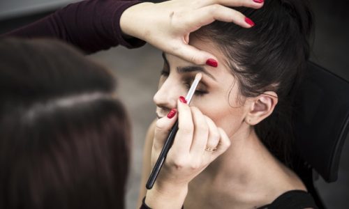 woman-applying-eye-shadow-model_23-2148328775
